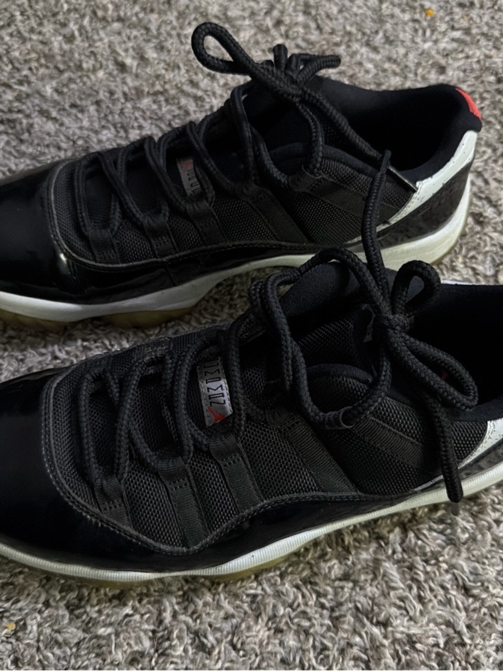 Jordan 11 Low Black and White Low-Top Sneakers with Red Accent